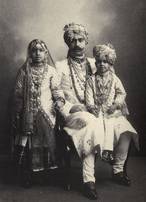 An Old Black And White Photo Of Three People