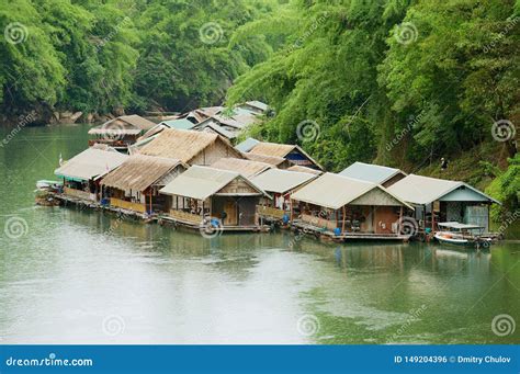 Traditional Thai Village With Floating Houses At The River Bank In
