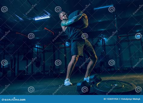 Young Healthy Man Athlete Doing Exercise In The Gym Stock Photo Image