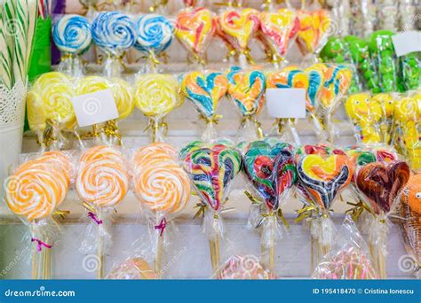 Group Of Vivid Coloured Sugar Lollipops In Display For Sale At A Candy