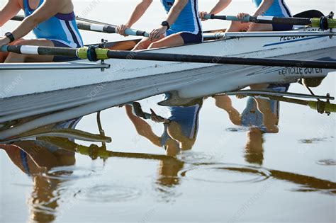 Reflection Of Female Rowers Rowing Scull On Lake Stock Image F021