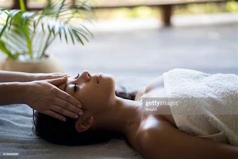 Relaxed Malaysian Woman Having A Head Massage At The Spa High Res Stock