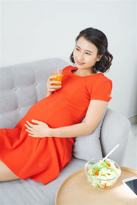 Premium Photo Pretty Young Asian Pregnant Woman Eating Salad And Drinking Milk When Sitting On