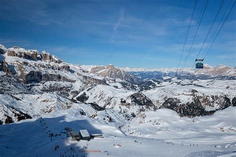 View Of A Ski Resort Piste With People Skiing In Dolomites In Italy