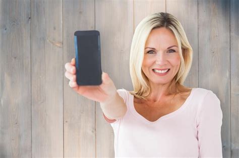 Premium Photo Happy Blonde Showing Her Smartphone Against Wooden Planks
