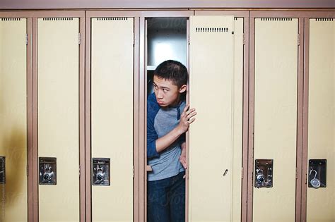 Scared High School Student Hiding Inside Locker By Rob And Julia Campbell