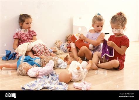 Little Girls Playing With Their Dolls Stock Photo Alamy