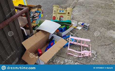 Broken Or Unwanted Childrens` Toys Left Out By Recycling Bin For