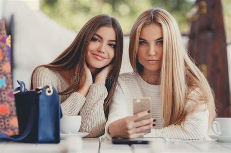 Blonde to brown/brunette hair before and after pictures; Two Girls Are Watching Photos On Smartphone Stock Photo ...