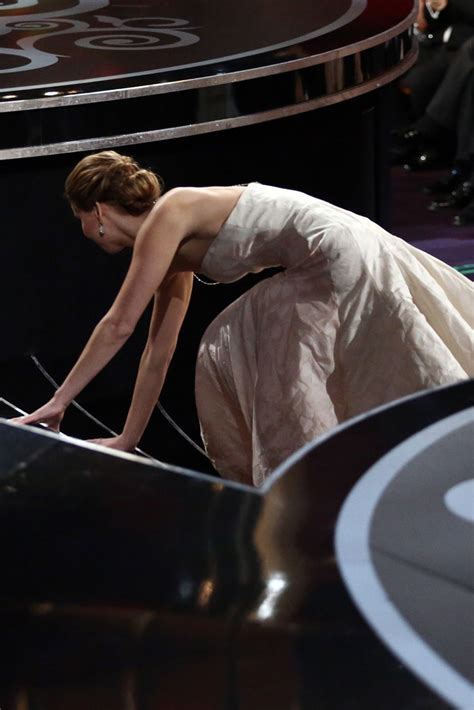 jennifer lawrence falls over as she collects best actress oscar