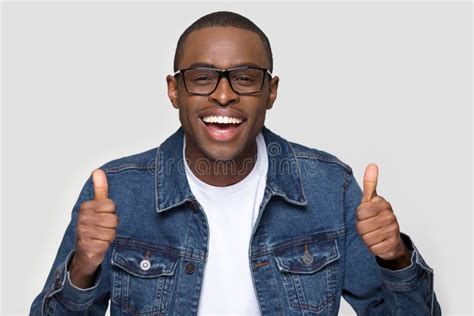 Happy African Man Showing Thumbs Up Laughing Looking At Camera Stock