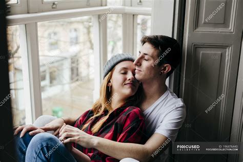 Sensual Couple Hugging With Closed Eyes On Window Sill Happiness Apartment Stock Photo