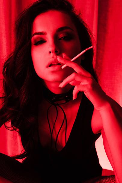Attractive Sensual Girl Smoking Cigarette In Red Free Stock Photo And Image
