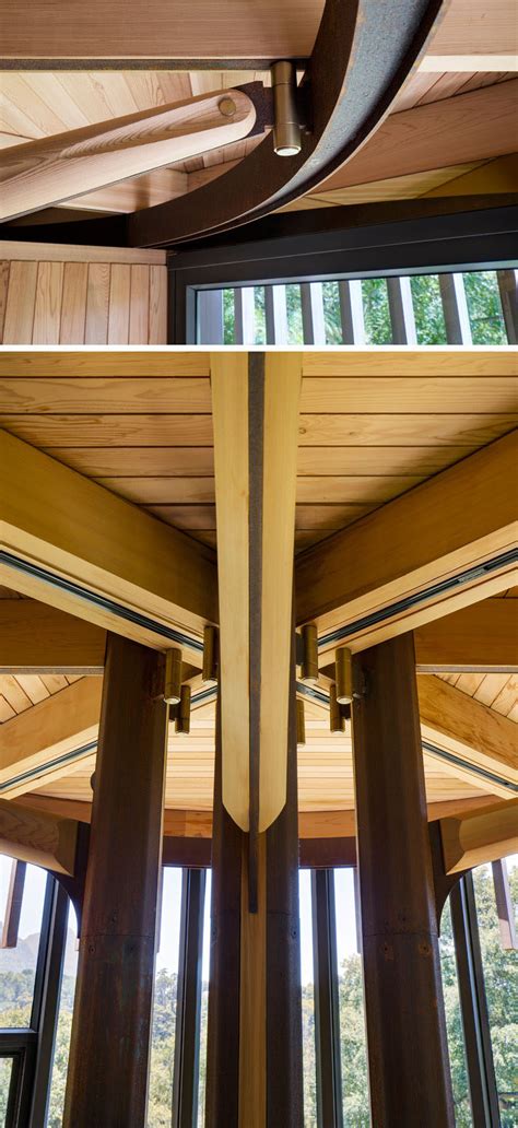 curvaceous wooden house sits   trees