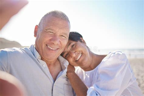 Affectionate Mature Mixed Race Couple Taking A Selfie Photograph On The