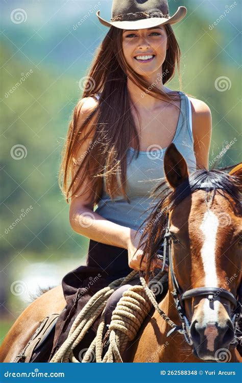 Loving The Outdoors Portrait Of A Beautiful Brunette Cowgirl With Her