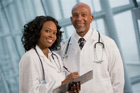 African Doctors Smiling With Medical Chart Stock Photo Dissolve