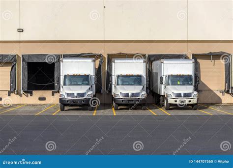 Small Compact Rigs Semi Trucks With Box Trailers Standing In Row At
