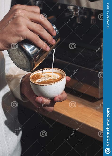 Close Up Hand Of Man Barista Pouring Froth Milk In Espresso Coffee In