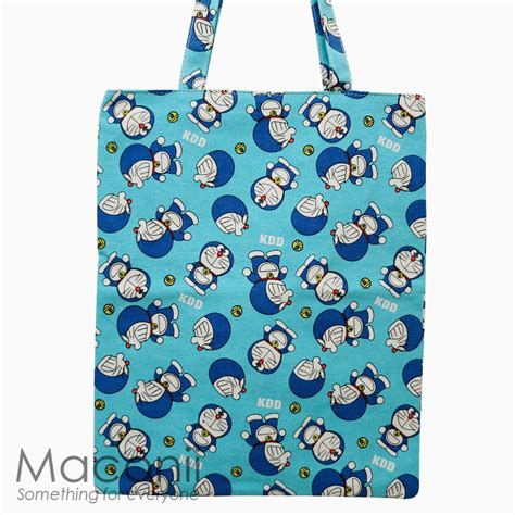 Easy to wear as a shoulder or cross body bag, styles vary from classic designs in elegant colors, such as black or blue, to vibrant patterns and refined details, for those who also want to carry a. Doraemon Tote Bag - Light Blue