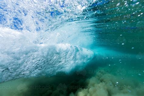 Image Of Under Water View Of An Ocean Wave Breaking In A Vortex On Sand
