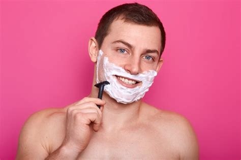Premium Photo Photo Of Shirtless Young Man Shaving His Face And