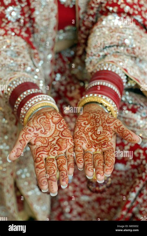 Close Up Henna Hands Indian Wedding Bride Wearing Red Bangles Stock