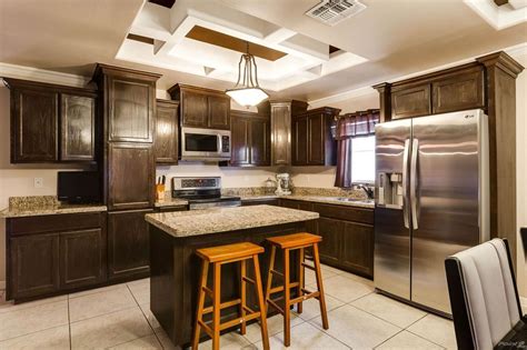 The metal tone is echoed in the sink faucet and overhead pendant lighting for a cohesive look throughout. Kitchen island and Multi level cabinets | Kitchen island ...