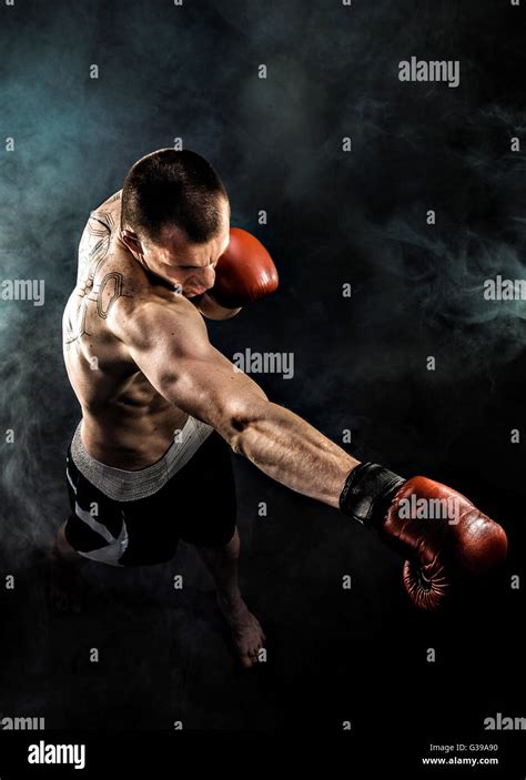 Muscular Kickbox Or Muay Thai Fighter Punching In Smoke Stock Photo Alamy