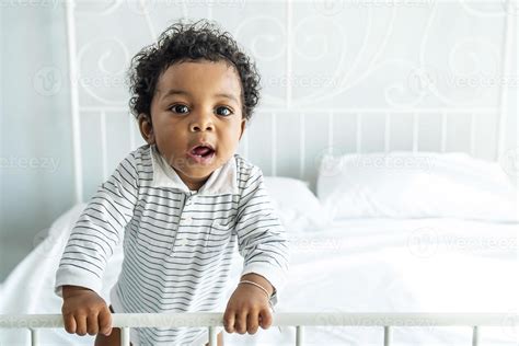 Adorable African Baby With Fluffy Hair Standing On The Bed Pretty Boy