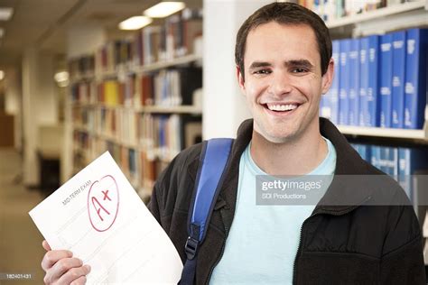 Happy College Student In Library Holding Excellent Grade On Exam High