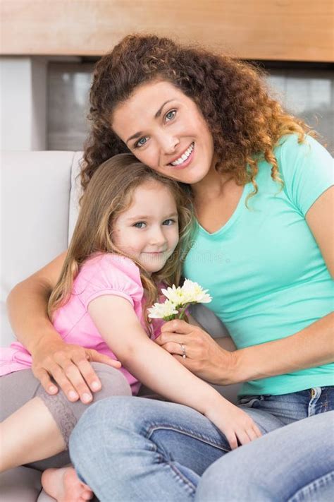 Smiling Mother Getting Little Flowers From Her Cute Daughter Stock
