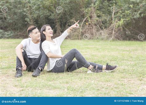 Loving Young Couple Sitting Down On Grass Stock Photo Image Of Dating