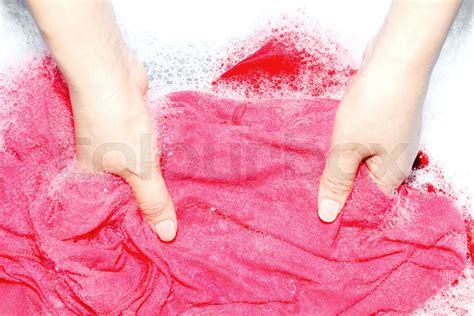 woman washing clothes by hand with detergent in plastic bowl stock image colourbox