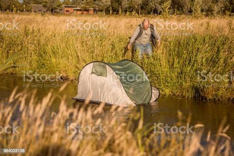 Handsome Redhead Father Chasing A Tent Caught In The Wind On A Camping