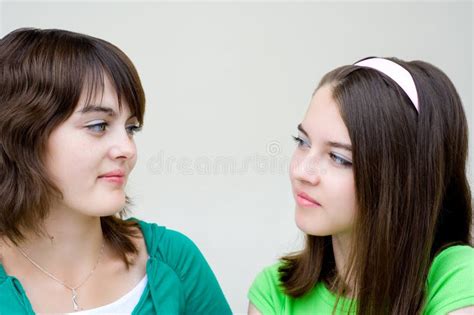 Two Beautiful Girls Look At Each Other Stock Image Image Of Closeup