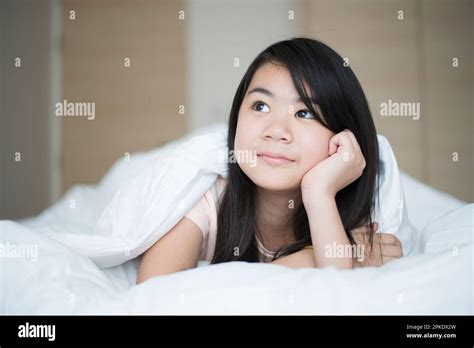 Girl Lying In Bed Stock Photo Alamy