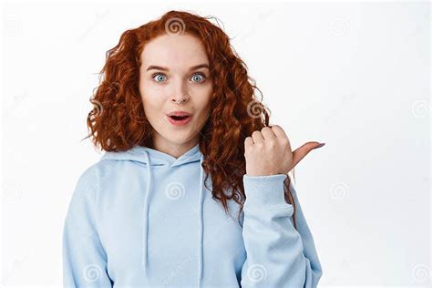 Wow Awesome Impressed Ginger Girl With Curly Hair Look Excited Pointing Finger Right And