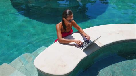 Woman Working On Laptop By The Pool Stock Footage Video 1040785