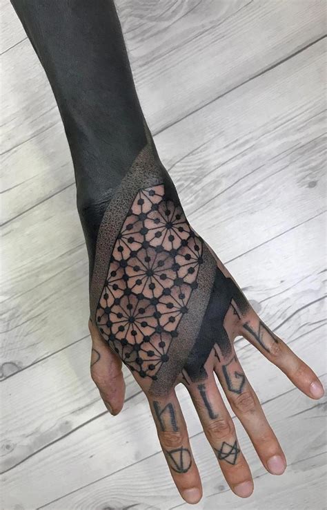 Geometric tattoos come in all different sizes and shapes and can be breathtakingly beautiful this is a realistic hand tattoo of a girl's face half of which is in light and the other half in darkness. blackout tattoo ideas © tattoo artist Nissaco 📌 📌 📌 # ...