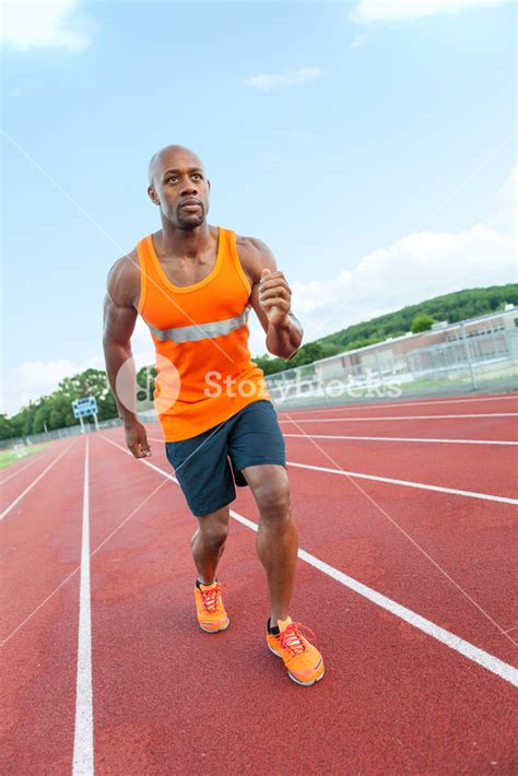 African American Man In His 30s Running At A Sports Track Outdoors