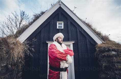 Iceland Santa Claus Standing In Front Of Cabin Looking At Distance