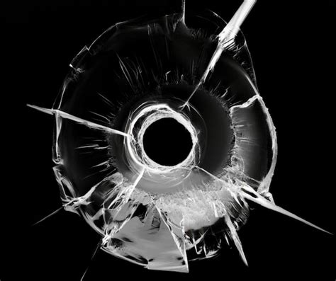 Premium Photo Bullet Hole In Glass On Black Cracked Glass Texture