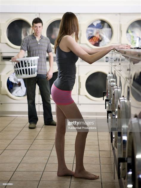 Woman Taking Off Her Clothes At The Laundromat Photo Getty Images
