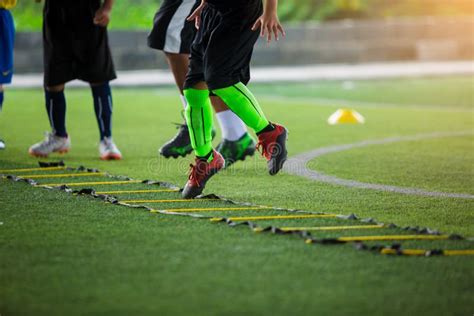 Kid Soccer Player Jogging And Jump Between Marker For Football Training