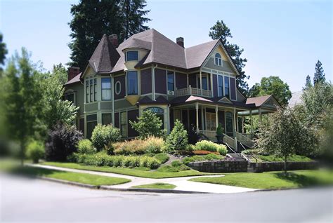 a large green house sitting on the side of a road