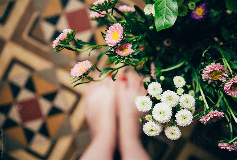 Woman Feet On Vintage Tiles Floor And Flowers By Vera Lair