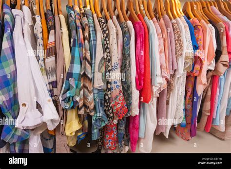 Variety Of Colorful Womens Clothing Hanging On Rail In Fashion Shop