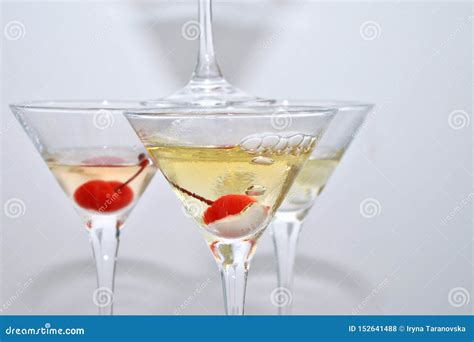 Three Martini Glasses With Cherries And Liquid Nitrogen Creating Steam Built In The Shape Of