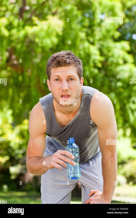 Sporty Man Drinking Water In The Park Stock Photo Alamy
